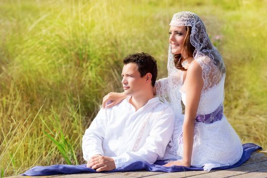 Couple mediterranean wedding day fashion in outdoor nature