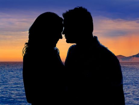 Couple in love hug in sunset on sea lake