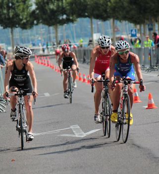 GENEVA, SWITZERLAND - JULY 22 : unidentified female cyclists, one obsreving others, at the International Geneva Triathlon, on July 22, 2012 in Geneva, Switzerland.