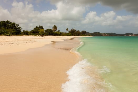 Sunny Tropical Caribbean Beach with Blue Cloudy Sky and Copy Space