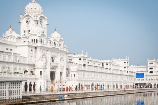 Amritsar, India - August 26, 2011: Pilgrims walk in the Harmandir Sahib Complex, the spiritual and cultural center of the Sikh religion