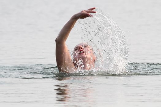 Smiling woman swimming in the water