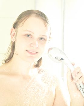Caucasian female showering, smiling and looking to the camera