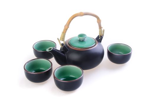 Chinese tea set with cups and tea pot on background.