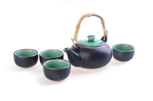 Chinese tea set with cups and tea pot on background.