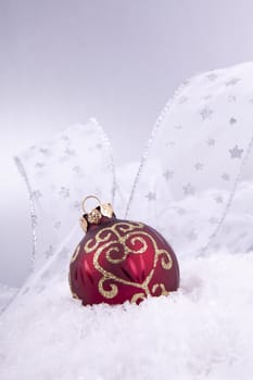 beautiful gold and red christmas decoration on white snow sparkle
