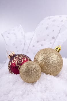 beautiful gold and red christmas decoration on white snow sparkle
