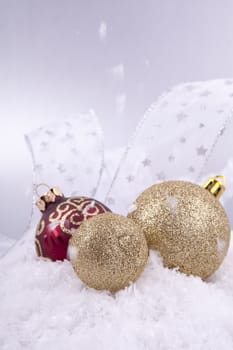 beautiful gold and red christmas decoration on white snow sparkle