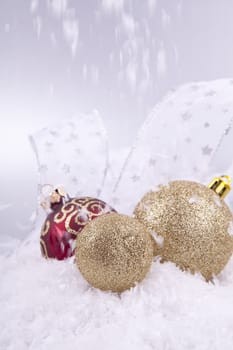 beautiful gold and red christmas decoration on white snow sparkle