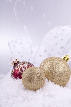 beautiful gold and red christmas decoration on white snow sparkle