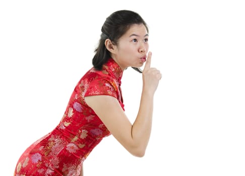 Asian female woman gesturing quiet sign, finger on lips over white background