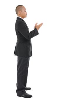 Male Muslim prayer in full business suit praying over white background