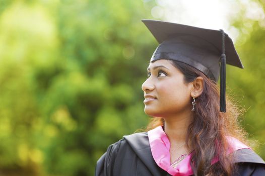 Smiling Young Asian Indian female student looking away with copy space
