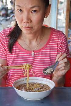 Asian woman eating  China noodle