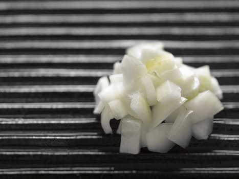 close up of chopped onions on a grill