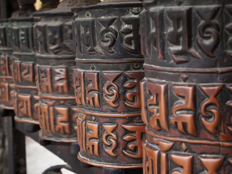 Decorated buddhist prayer wheels in a stupa.