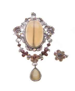 brooch with different gems on a background.