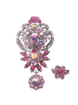 brooch with different gems on a background.