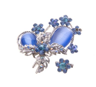 brooch with different gems on a background.