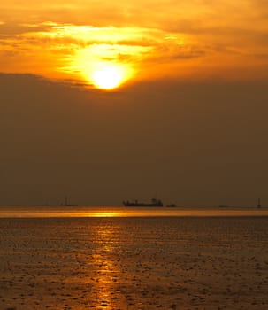 Golden sea with ocean liner at sunset