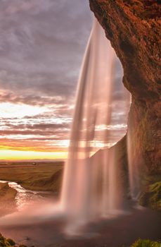 Seljalandsfoss is one of the most beautiful waterfalls on the Iceland. It is located on the South of the island. This photo is taken during the incredible sunset at approx. 1 AM. 