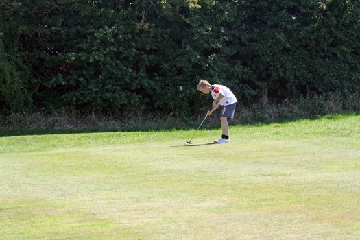 teenage boy playing golf