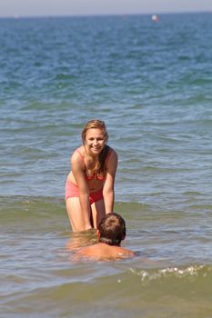 teenagers in the sea at cromer england