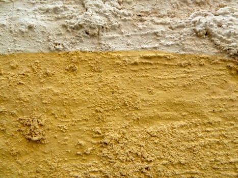 yellow and white painted rough wall
