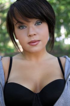 Beautiful lady in a black bra in the woods