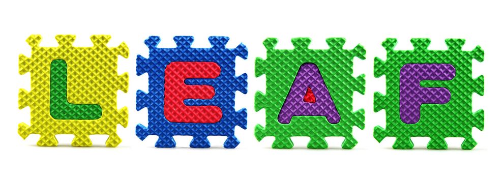 Alphabet puzzle pieces on white background