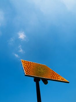 Solar panel under blue sky with clouds