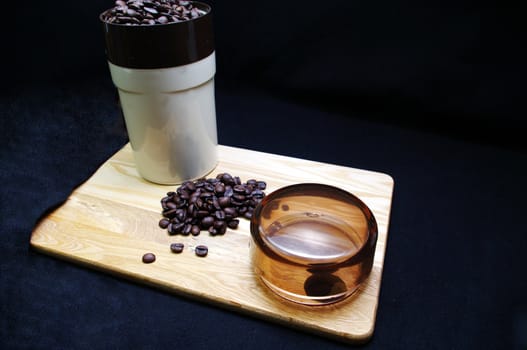 Coffee beans and a grinder on a wooden tray