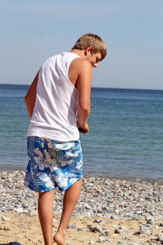 teenage boy looking out to sea