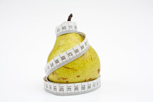 Tape measure wrapped around the pear, close-up.