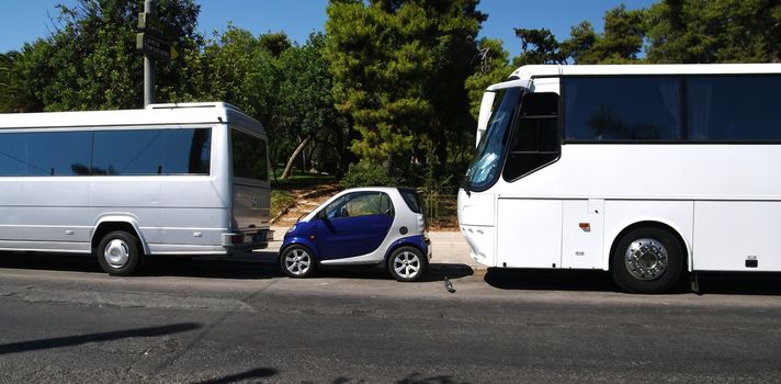 Just space enough for a small car between to busses