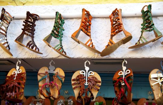Sandals with different colors hanging on a wall