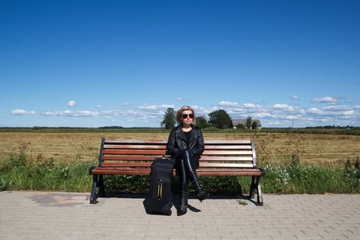 lonely bus stop at countryside with women on bench