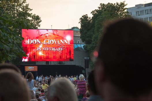 STUTTGART, GERMANY - JULY 25: More than 5.000 people are watching the public viewing of the premiere of Mozart´s opera “Don Giovanni” on a large screen in front of the Opera building in Stuttgart, Germany on July 25, 2012.
