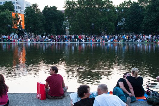 STUTTGART, GERMANY - JULY 25: More than 5.000 people are watching the public viewing of the premiere of Mozart´s opera “Don Giovanni” on a large screen in front of the Opera building in Stuttgart, Germany on July 25, 2012.