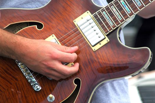 Guitarist performing on stage in concert.