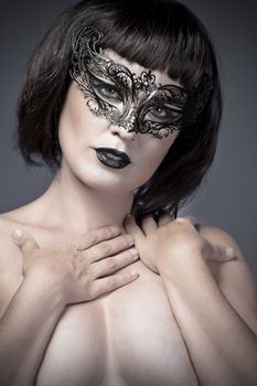 Nude woman, beautiful young in a black mysterious venetian mask