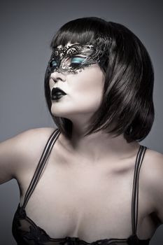 Elegant and beautiful brunette with delicate Venetian mask