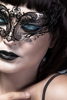 Detail of face of beautiful and sexy woman with delicate Venetian mask