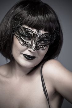 Warm woman with Venetian mask and corset, sensual, sexy and attractive