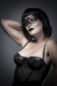 Beautiful woman with Venetian mask and corset, sensual, sexy and attractive