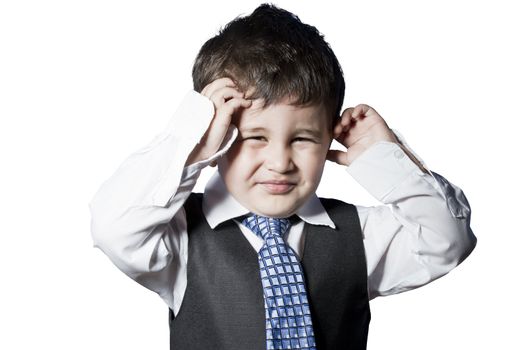 Child dressed like businessman with hands on his face funny