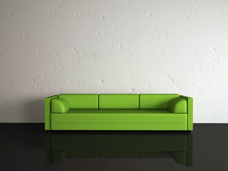 The green sofa near a white wall