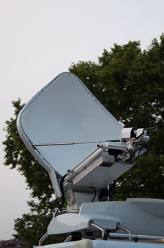 White broadcast truck recording and broadcasting a live event