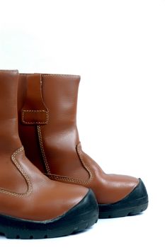 a pair of brown leather boots isolated on white background