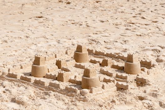 Kids sand castle construction on clean sandy beach